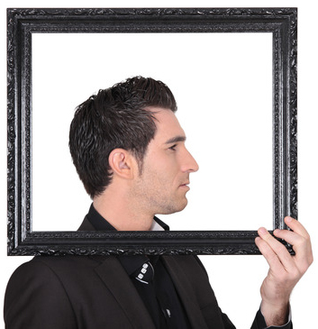 Man holding up a picture frame around his head